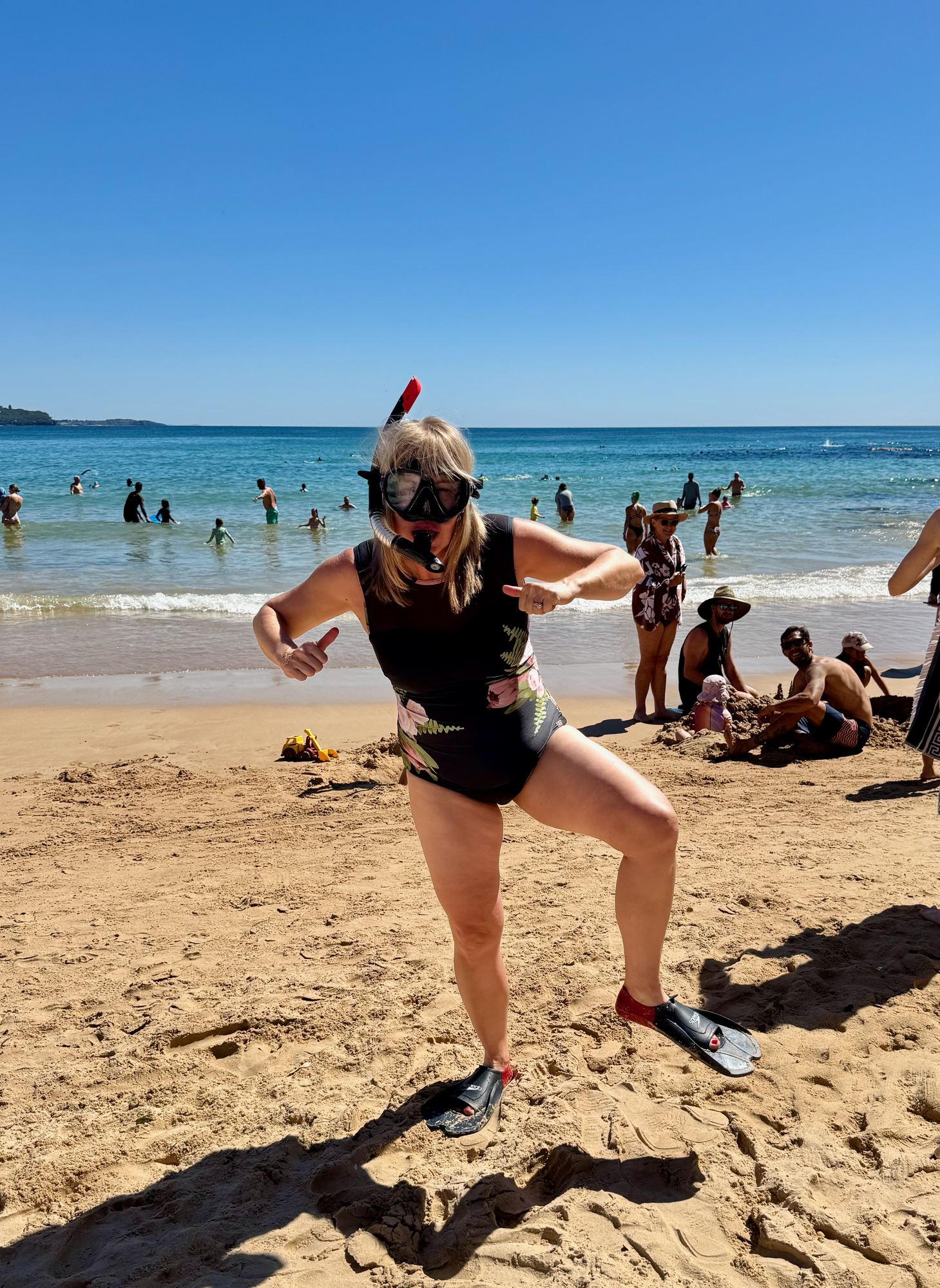 Kara striking a pose in snorkel gear on the beach